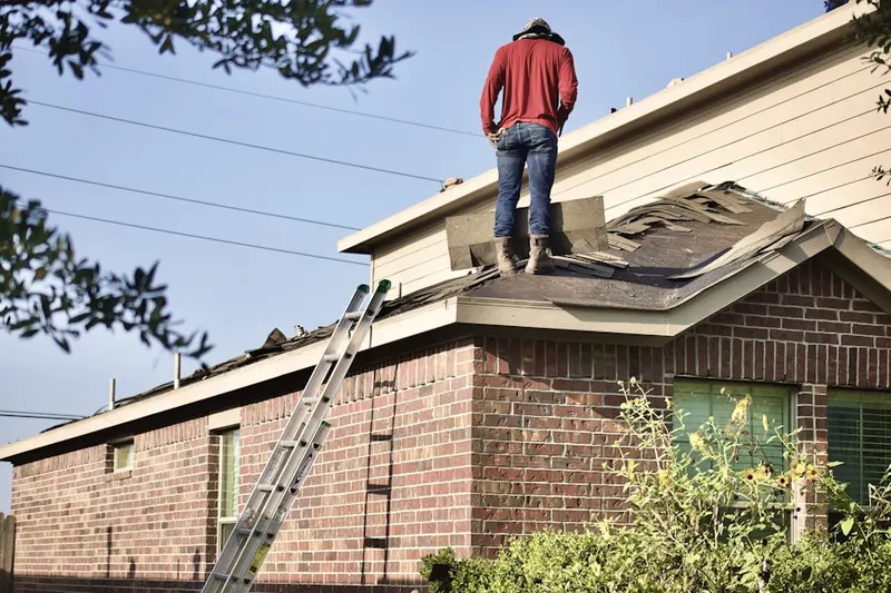 Professional roofer working on a residential roof in Hoerr